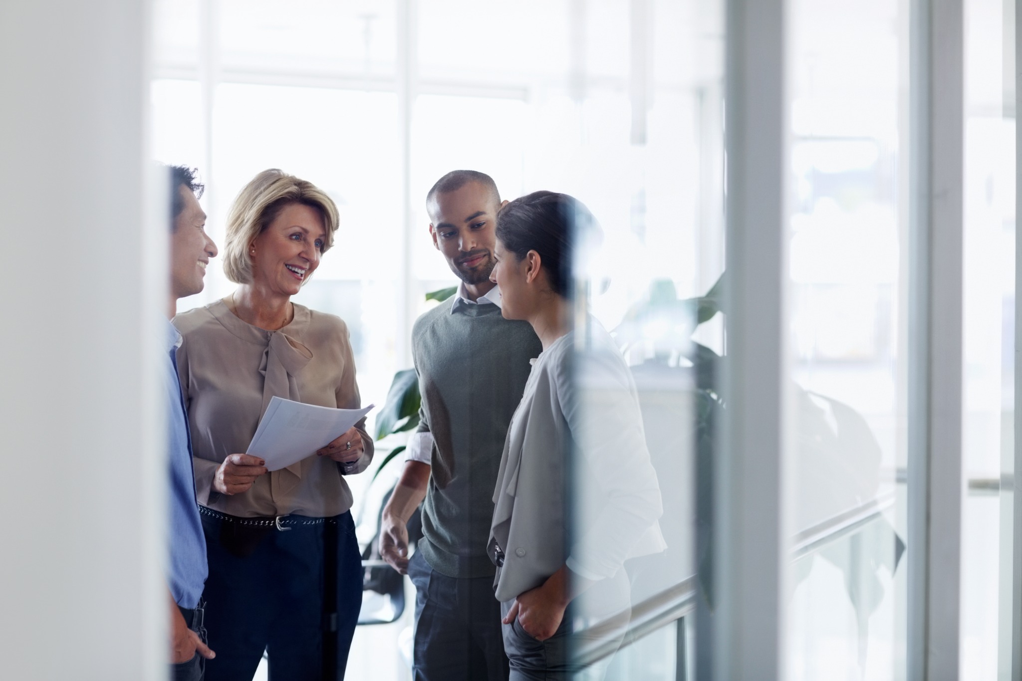 Colleagues sharing ideas during a conversation in a bright office.