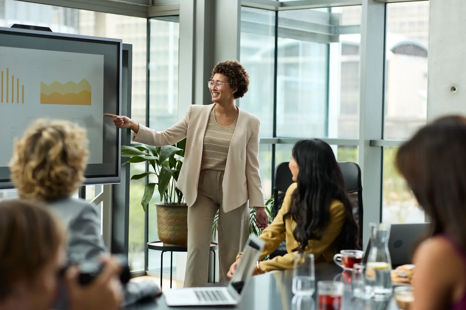 A clinical data management leader presenting analysis to colleagues during a team meeting.